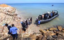 FILE: Migrants from Africa arrive on shore after being rescued by Libyan coast guards rescued at sea, off the coastal town of Tajoura, 15 kilometres east of the capital Tripoli, on 23 May 2017. Picture: AFP