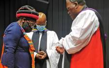 Bishop of Makhanda, Ebenezer Ntlali anoints Ntsiki Biko following the awarding of the Honorary Doctrate of Laws Degree by Rhodes University at the Steve Biko Centre. Picture: Steve Biko Foundation.