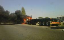 A truck was set alight on the M2 near Germiston on 27 September 2012, allegedly by striking satawu members. Picture: iWitness