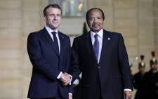 French President Emmanuel Macron greets Cameroon President Paul Biya prior to a dinner with the participants of the Paris Peace Forum at the Elysee Palace, in Paris, on 11 November 2019. Picture: AFP