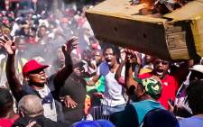Fees2017 protesters fling a burning mock coffin into police barricade during the protesters march to parliament on the 26th October 2016. Picture: Anthony Molyneaux/EWN