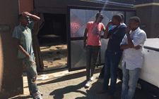 The entrance to the bedroom where Flabba was stabbed at his house in Alexandra. His brother (in blue) standing outside. Picture: Govan Whittles/EWN.