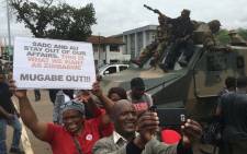 Zimbabweans take selfies with soldiers during a protest march against President Robert Mugabe on 18 November 2017. Picture: EWN