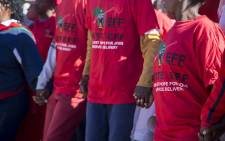 EFF members hold hands during the party's march in Coligny in the North West against what residents call bias & inefficient police in the area on 19 May 2017. Picture: Reinart Toerien/EWN.