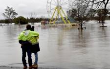 People look at a flooded park due to torrential rain in the Camden suburb of Sydney on July 3, 2022. Picture:Muhammad FAROOQ / AFP.