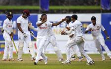 Sri Lanka's cricketers celebrate their victory at the end of the fifth day of the first Test match between Sri Lanka and West Indies at the Galle International Cricket Stadium in Galle on 25 November 2021. Picture: ISHARA S. KODIKARA/AFP