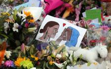 A poster at a memorial site for the victims of mosque attacks in Christchurch on 19 March 2019. Picture: AFP