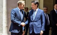 European Council President Donald Tusk (left) shake hands with Italian Prime Minister Giuseppe Conte (R) on June 20, 2018 at Chigi palace in Rome. Picture: AFP