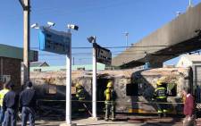 Firefighters contain a fire that left one train carriage damaged at Koeberg Train Station, Cape Town. Picture: Bertram Malgas/EWN