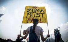 A woman holds up a banner at the Freedom Movement rally against the leadership of President Jacob Zuma in Pretoria on 27 April 2017. Picture: Reinart Toerien/EWN