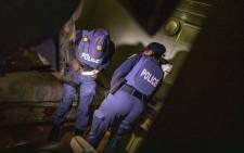 FILE: Police officers during raid. Picture: Thomas Holder/EWN
