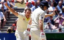 Australia's paceman Josh Hazlewood (L) celebrates dismissing England batsman Chris Woakes (R) on the final day of the second Ashes cricket Test match in Adelaide in 6 December, 2017. Picture: AFP.