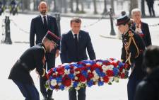 French President Emmanuel Macron lays a wreath of flowers during a ceremony to mark the end of World War II at the Arc de Triomphe in Paris on 8 May 2020. Picture: AFP