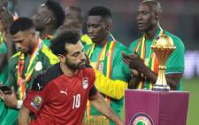 Egypt's forward Mohamed Salah walks past the trophy after losing the Africa Cup of Nations 2021 final football match between Senegal and Egypt at Stade d'Olembe in Yaounde on February 6, 2022. Picture: Kenzo Tribouillard / AFP