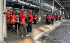 Numsa members wait outside the Cape Town International Convention Centre on 25 July 2022 following the labour court’s halting of the union’s congress. Picture: Theto Mahlakoana/Eyewitness News