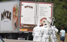 In this file photo taken on 27 August 2015 forensic investigators work on a refrigerated truck parked along a highway near Neusiedl am See, Austria, after the bodies of 71 migrants where found suffocated in the lorry.  Picture: AFP.