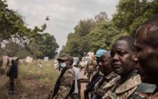 FILE: Central African Republic Prime Minister Firmin Ngrebada (2nd R), salutes his troops on the road between Boali and Bangui, on 10 January 2021. Picture: FLORENT VERGNES/AFP