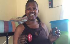 Diepsloot resident Mpho Pasha with the remotes to her alarm system. Picture: Vumani Mkhize/EWN.