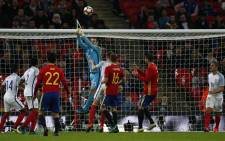 England's goalkeeper Tom Heaton (C) punches the ball away during the friendly international football match between England and Spain at Wembley Stadium, north-west London, on 15 November, 2016. The match ended in a draw at 2-2. Picture: AFP.
