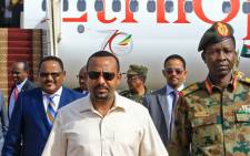 This file photo taken on 7 June 2019 shows Ethiopia's Prime Minister Abiy Ahmed (C-L) walks alongside Shams-Eddin Kabashi Sudan's Transitional Military Council (TMC) spokesman (C-R) upon his arrival at Khartoum international airport on 7 June 2019. Picture: AFP