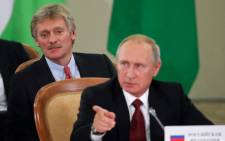FILE: Russia's President Vladimir Putin (front) and Kremlin spokesman Dmitry Peskov attend a session of the Council of Heads of the Commonwealth of Independent States (CIS) in Sochi on 11 October 2017. Picture: AFP