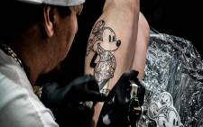FILE: Tattoo artist Adrian Wright works on a client. Picture: Supplied