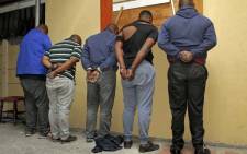 FILE: Five suspects in handcuffs following their arrest for possession of stolen vehicles and prohibited firearms at Bishop Lavis in Cape Town. Picture: SAPS