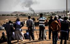 FILE: Smoke rises from the Syrian town of Kobani, seen from near the Mursitpinar border crossing on the Turkish-Syrian border. Picture: AFP. 