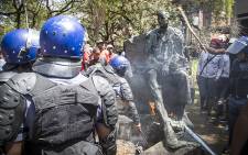 Police negotiated with University of the Free State students to disperse after they vandalised a statue of apartheid era leader CR Swart. Picture: Reinart Toerien/EWN.
