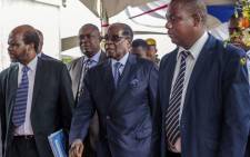 FILE: Zimbabwe's former President Robert Mugabe (centre) arrives for a graduation ceremony at the Zimbabwe Open University in Harare on 17 November 2017. This is his first public appearance since a military takeover on 14 November 2017. Picture: AFP
