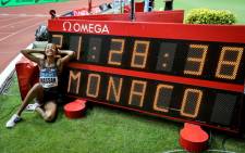 Sifan Hassan of the Netherlands poses in front of a screen reading her new world record in the Women's mile during the IAAF Diamond League competition on 12 July 2019 in Monaco. Picture: AFP