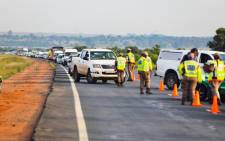 Traffic officers conduct checks at a roadblock. Picture: @Dotransport/Twitter
