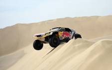 Peugeot driver Stephane Peterhansel drops down a sand dune in the Dakar Rally on 8 January, 2018. Picture: AFP