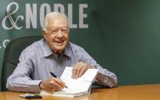 File picture taken 7 July, 2015 shows former US President Jimmy Carter signing his new Book A Full Life: Reflections at Ninety at Barnes & Noble on 5th avenue in New York. Picture: AFP.