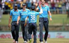 England bowler Steven Finn (R) is congratulated by his teammates after a taking a wicket during a tri-series match in Australia, December 2014. Picture: Official ECB Facebook.