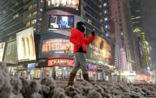 Few people walk on a deserted street in New York’s Times Square during a snow storm on 26 January 2015. Picture: AFP.