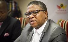 FILE: Police Minister Fikile Mbalula leaves a media briefing at the Hawks head office in Pretoria. Picture: EWN.