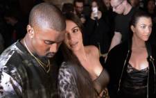 FILE: This file photo shows (From L) Kanye West, Kim Kardashian and Kourtney Kardashian attending the Off-white 2017 Spring/Summer fashion show. Picture: AFP.