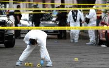 Forensic experts are seen at the scene of the crime where Mexican musician Willie, a member of the Sonora Tropicana band, was killed by armed men in Guadalajara, Jalisco state, on 18 January, 2019. Picture: AFP.
