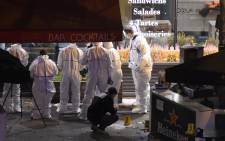 Forensic experts inspect the site of an attack, a restaurant outside the Stade de France stadium in Saint-Denis, north of Paris, early on November 14, 2015, after a series of gun attacks occurred across Paris.  Picture: AFP