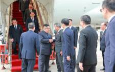 In this picture taken on June 10, 2018 and released from North Korea's official Korean Central News Agency (KCNA) on June 11, 2018, North Korean leader (centre L) is greeted by Singapore's Foreign Minister Vivian Balakrishnan (centre R) upon his arrival in Singapore. Picture: AFP.