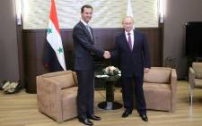 Russia's President Vladimir Putin (R) shakes hands with his Syrian counterpart Bashar al-Assad during a meeting in Sochi on November 20, 2017. Picture: AFP