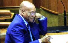 President Jacob Zuma smiles at Mmusi Maimane's accusations at Sona debate. Picture: Thomas Holder/EWN.