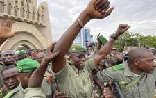 Colonel Malick Diaw (C), vice-president of the CNSP (National Committee for the Salvation of the People) gestures to a crowd of supporters as he arrives escorted by Malian soldiers at the Independence square in Bamako, on 21 August 2020. Picture: AFP.

