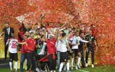 Wydad's players celebrate with the trophy after winning the CAF Champions League Semi-Final between Egypt's al-Ahly and Morocco's Wydad AC at Stade Mohammed V in the Moroccan city of Casablanca on May 30, 2022. Picture: AFP.