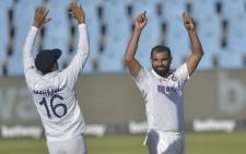India's Mohammed Shami (R) celebrates with teammate India's Mayank Agarwal (L) after the dismissal of South Africa's Kagiso Rabada (not seen) during the third day of the first Test cricket match between South Africa and India at SuperSport Park in Centurion on December 28, 2021. Picture: Christiaan Kotze / AFP