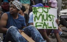 A University of the Free State student holds up a placard calling for the removal of the institutions Vice Chancellor Jonathan Jansen during protests on main campus in Bloemfontein. Picture: Reinart Toerien/EWN.