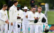 FILE: South Africa's captain Dean Elgar (2nd R) and his teammates leave the field after winning the second cricket Test match against New Zealand at Hagley Oval in Christchurch on 1 March 2022. Picture: Sanka Vidanagama/AFP