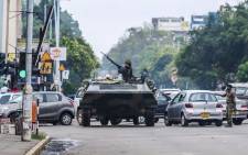 An armoured personnel carrier at an intersection as Zimbabwean soldiers regulate traffic in Harare on 15 November 2017. Picture: AFP.