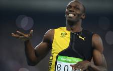 Jamaica’s Usain Bolt celebrates after he won the Men’s 100m Final during the athletics event at the Rio 2016 Olympic Games at the Olympic Stadium in Rio de Janeiro on 14 August, 2016. Picture: AFP.